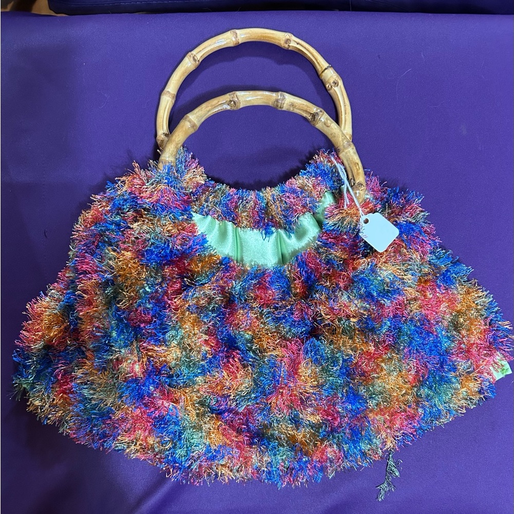 Brand new handmade pouf bamboo handle bag. Will fit cell phone. Adorable for all